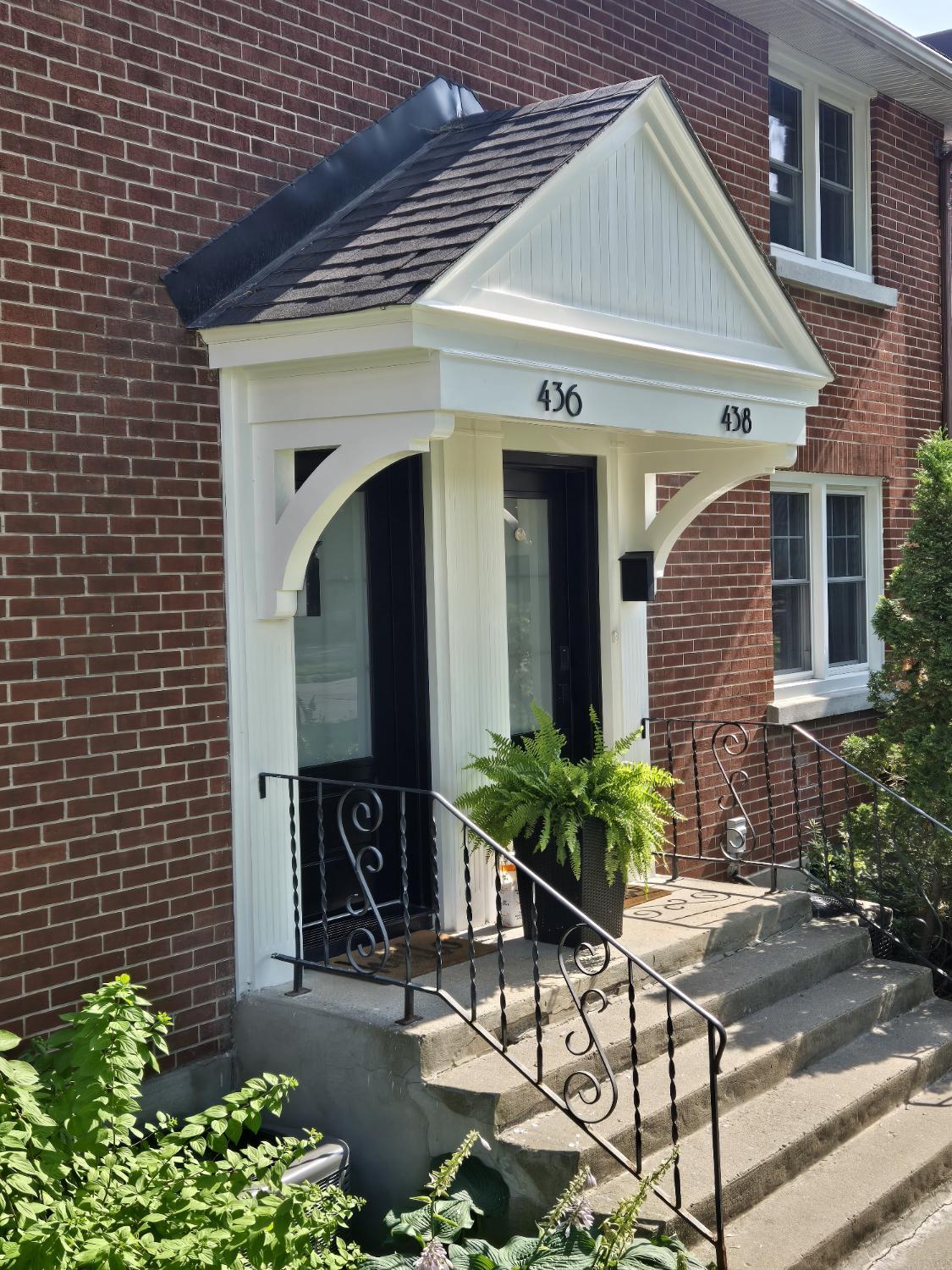 White gabled portico on brick house